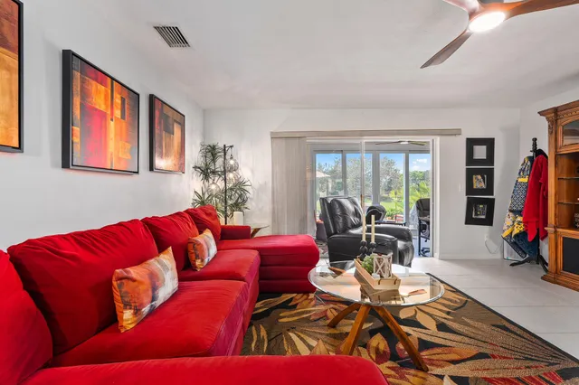 a front view of a house with a garden and trees