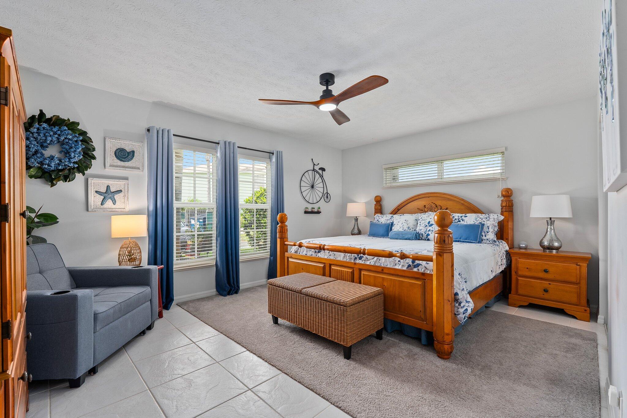 2186 Southeast Wild Meadow Circle Port St. Lucie, FL 34952 - Photo 25 of 57 a bedroom with a bed and wooden floor