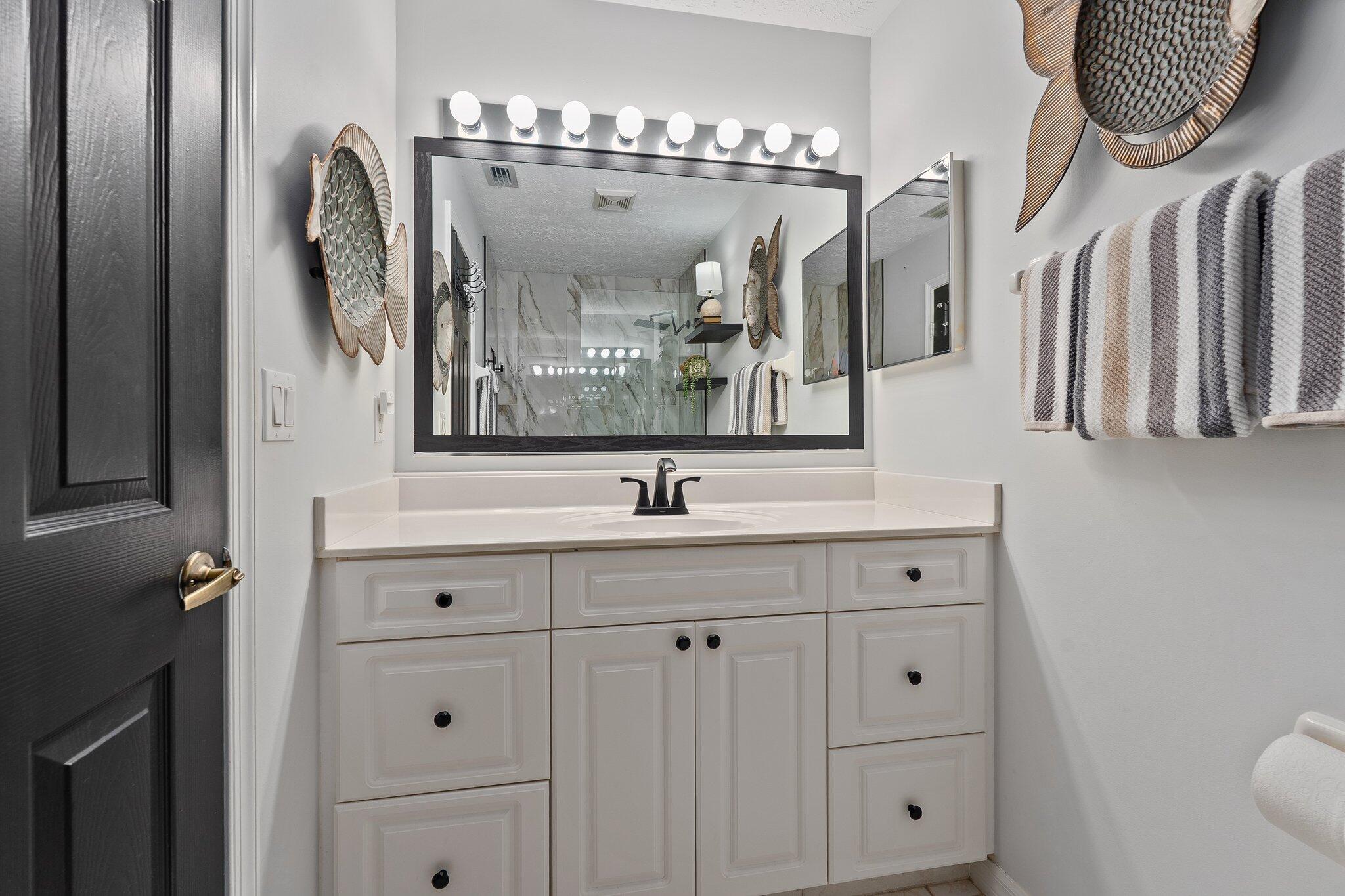 2186 Southeast Wild Meadow Circle Port St. Lucie, FL 34952 - Photo 28 of 57 a bathroom with double vanity sink and two mirror