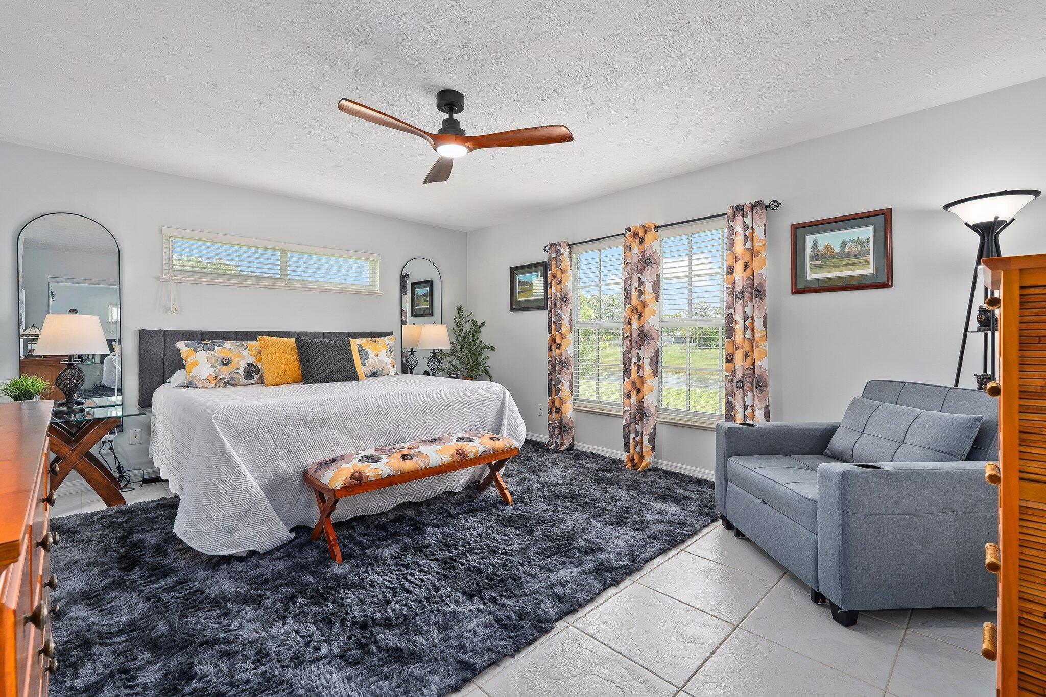 2186 Southeast Wild Meadow Circle Port St. Lucie, FL 34952 - Photo 31 of 57 a bedroom with a bed and couch
