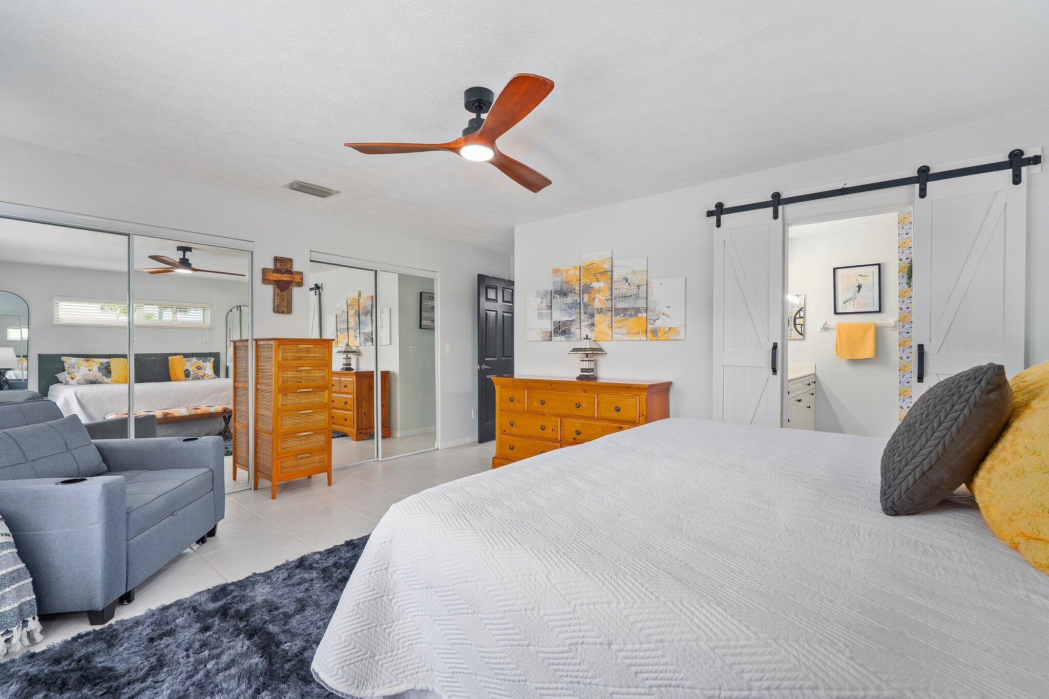 2186 Southeast Wild Meadow Circle Port St. Lucie, FL 34952 - Photo 33 of 57 a bedroom with a bed and wooden floor