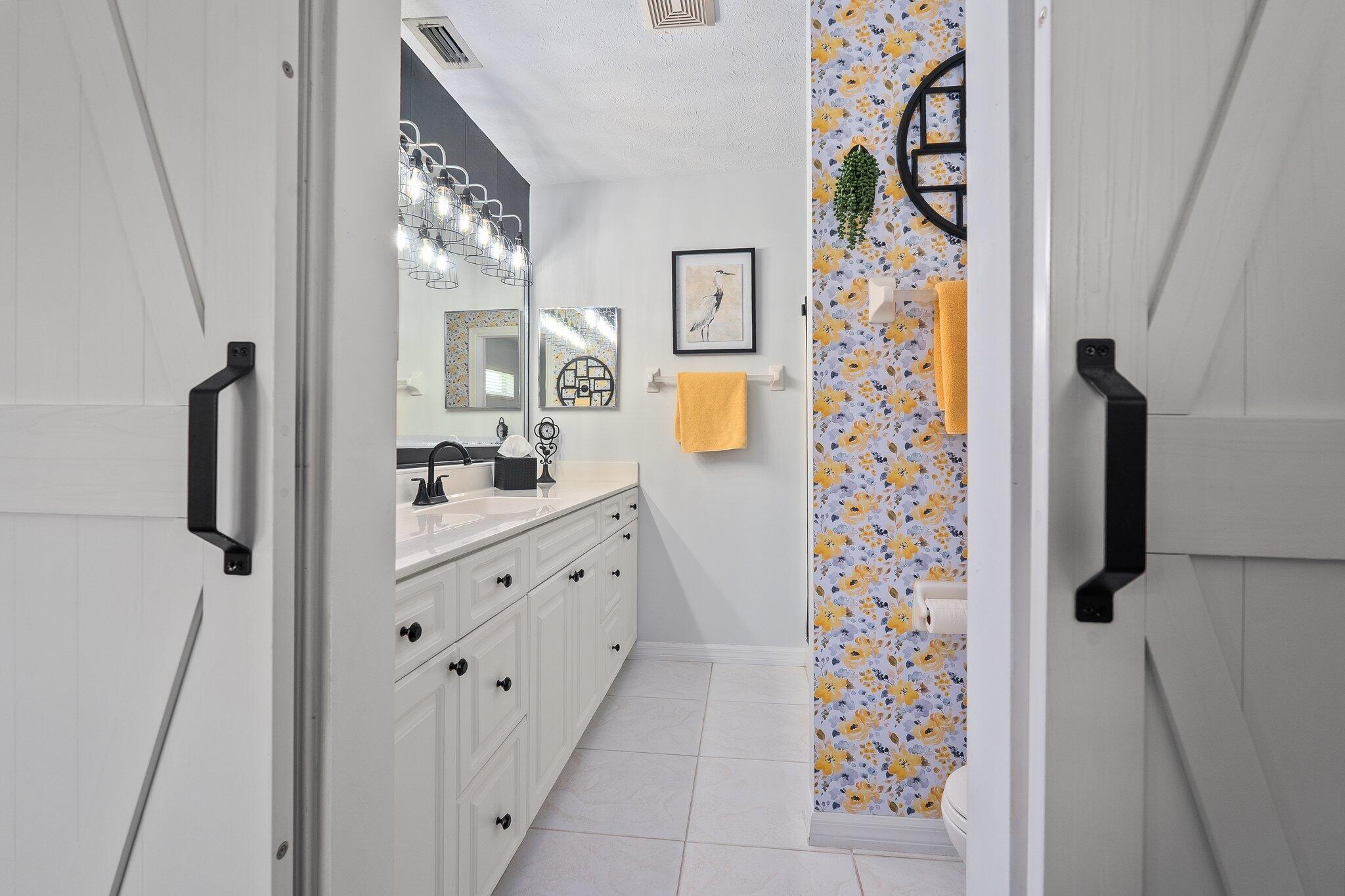 2186 Southeast Wild Meadow Circle Port St. Lucie, FL 34952 - Photo 34 of 57 a bathroom with a sink and a mirror