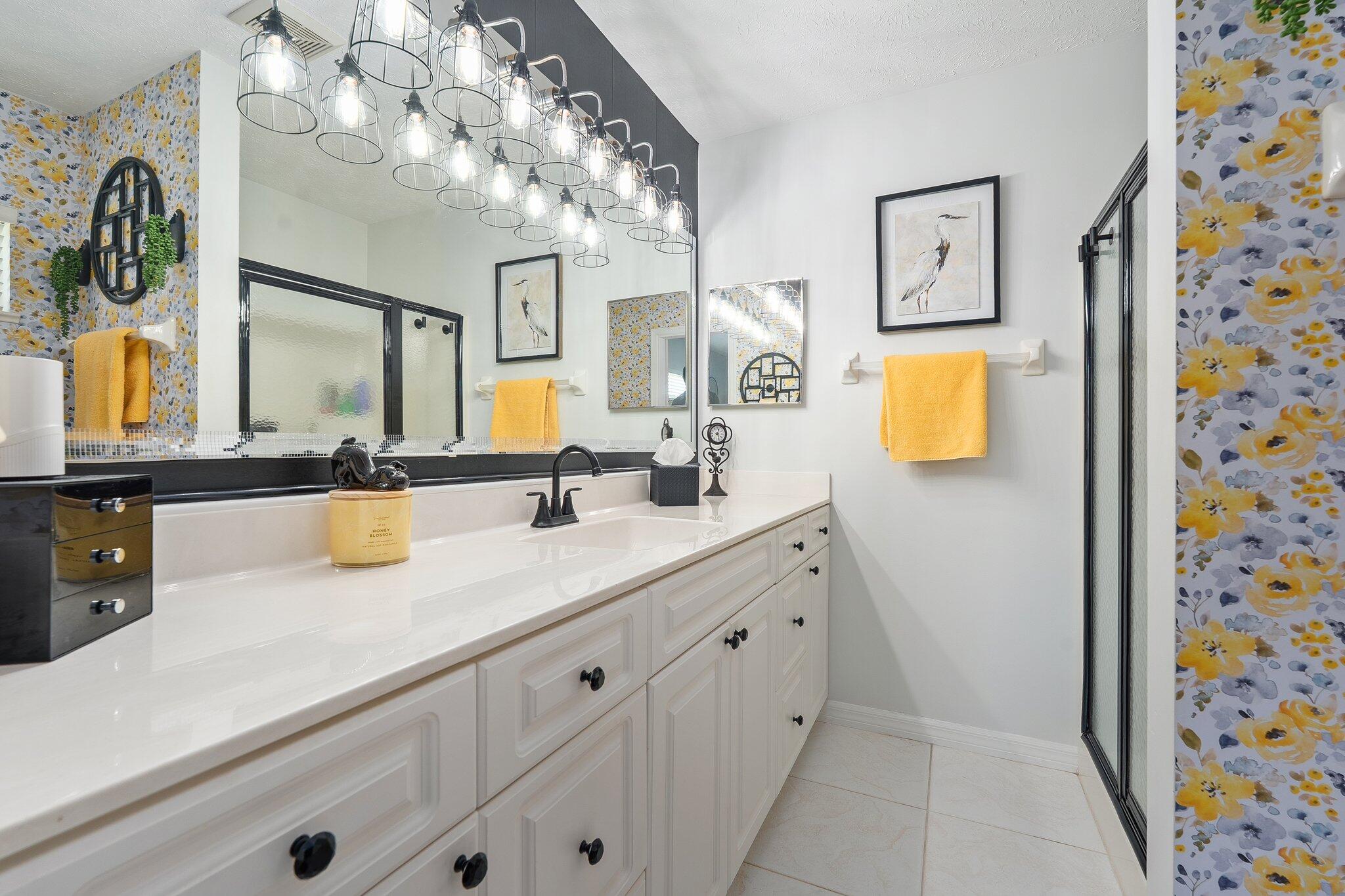 2186 Southeast Wild Meadow Circle Port St. Lucie, FL 34952 - Photo 35 of 57 a bathroom with a sink a mirror and a shower curtain
