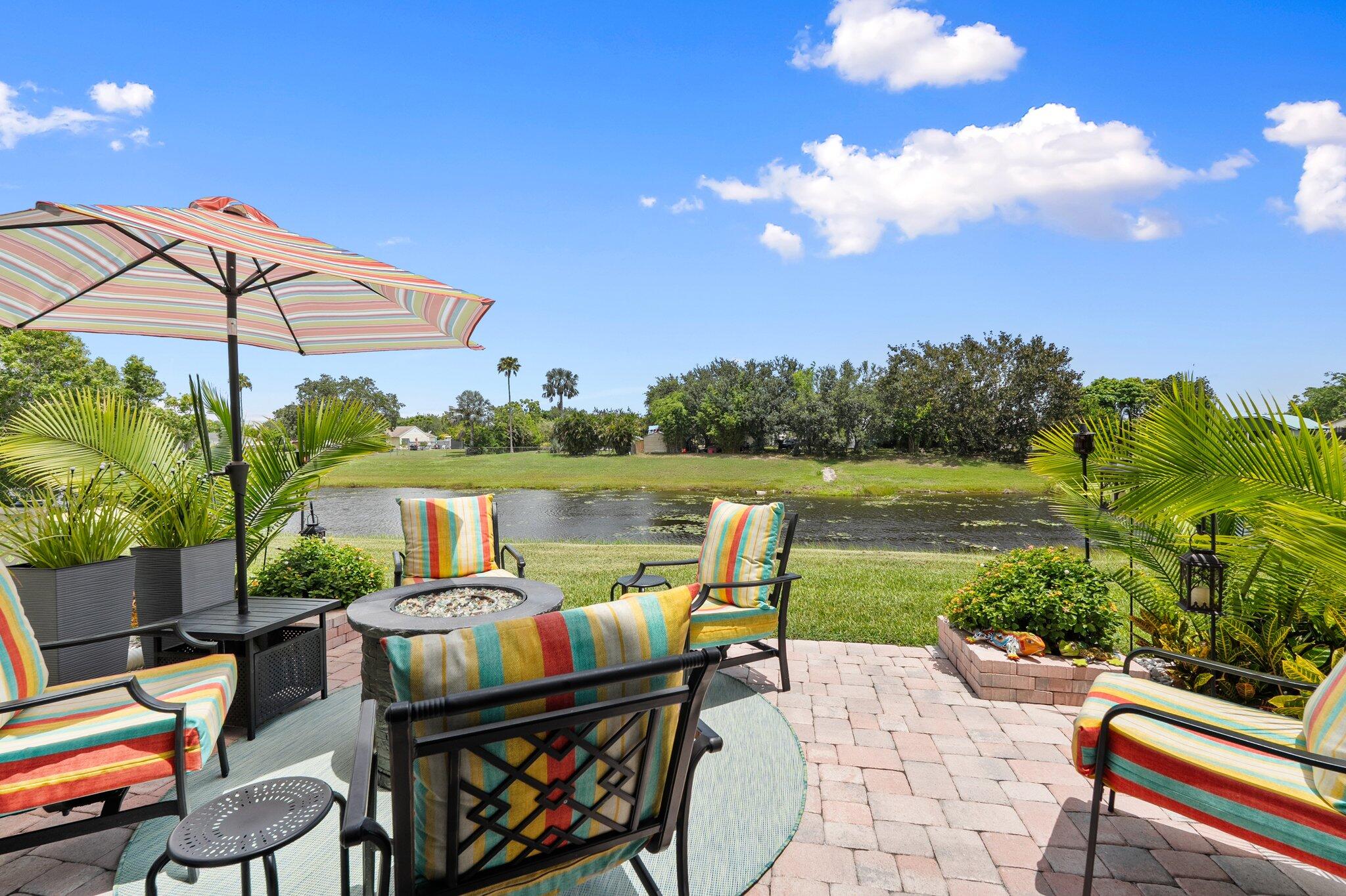 2186 Southeast Wild Meadow Circle Port St. Lucie, FL 34952 - Photo 39 of 57 a patio with water view fountain and a table