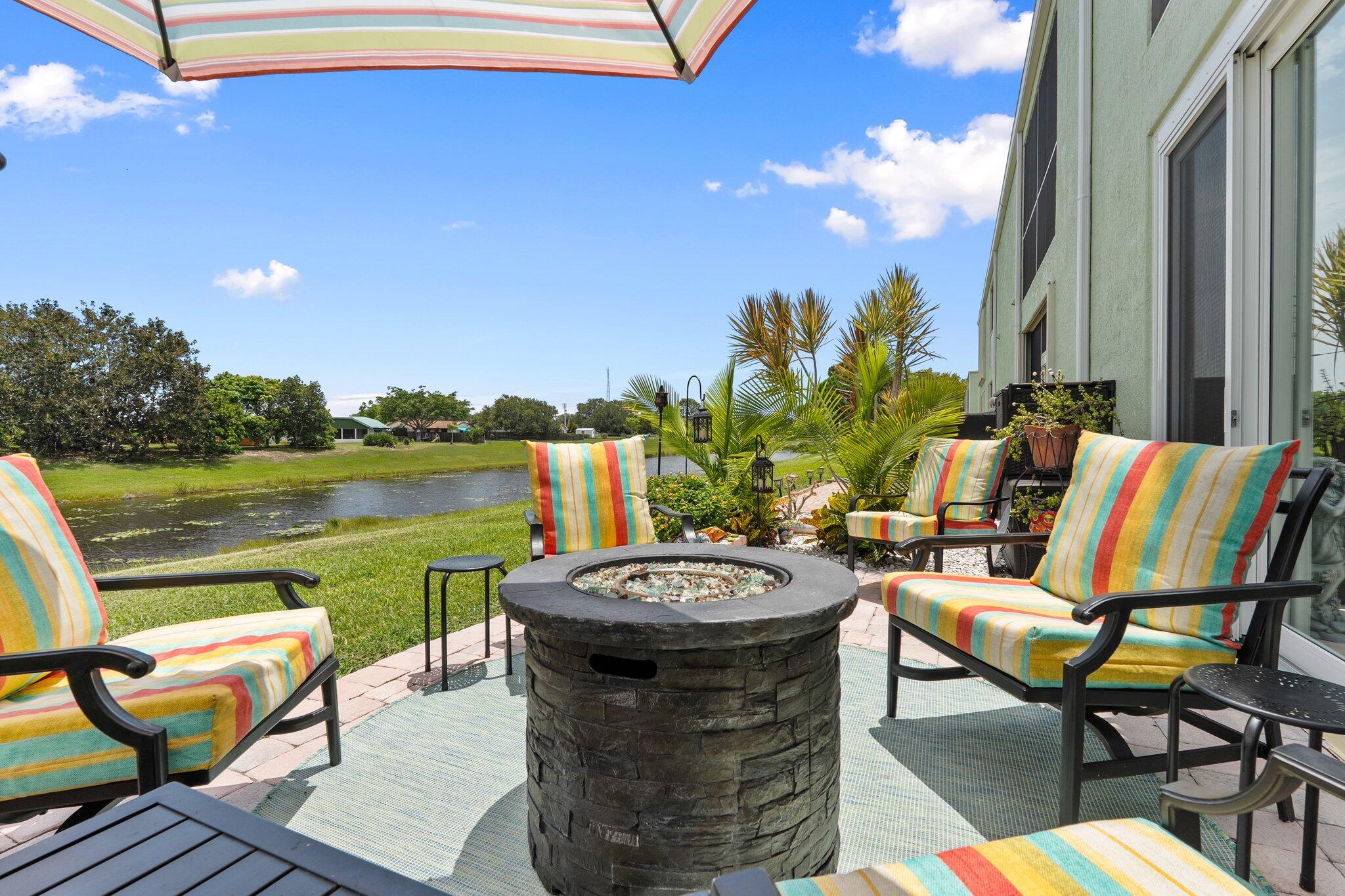 2186 Southeast Wild Meadow Circle Port St. Lucie, FL 34952 - Photo 42 of 57 a view of a swimming pool with lounge chairs