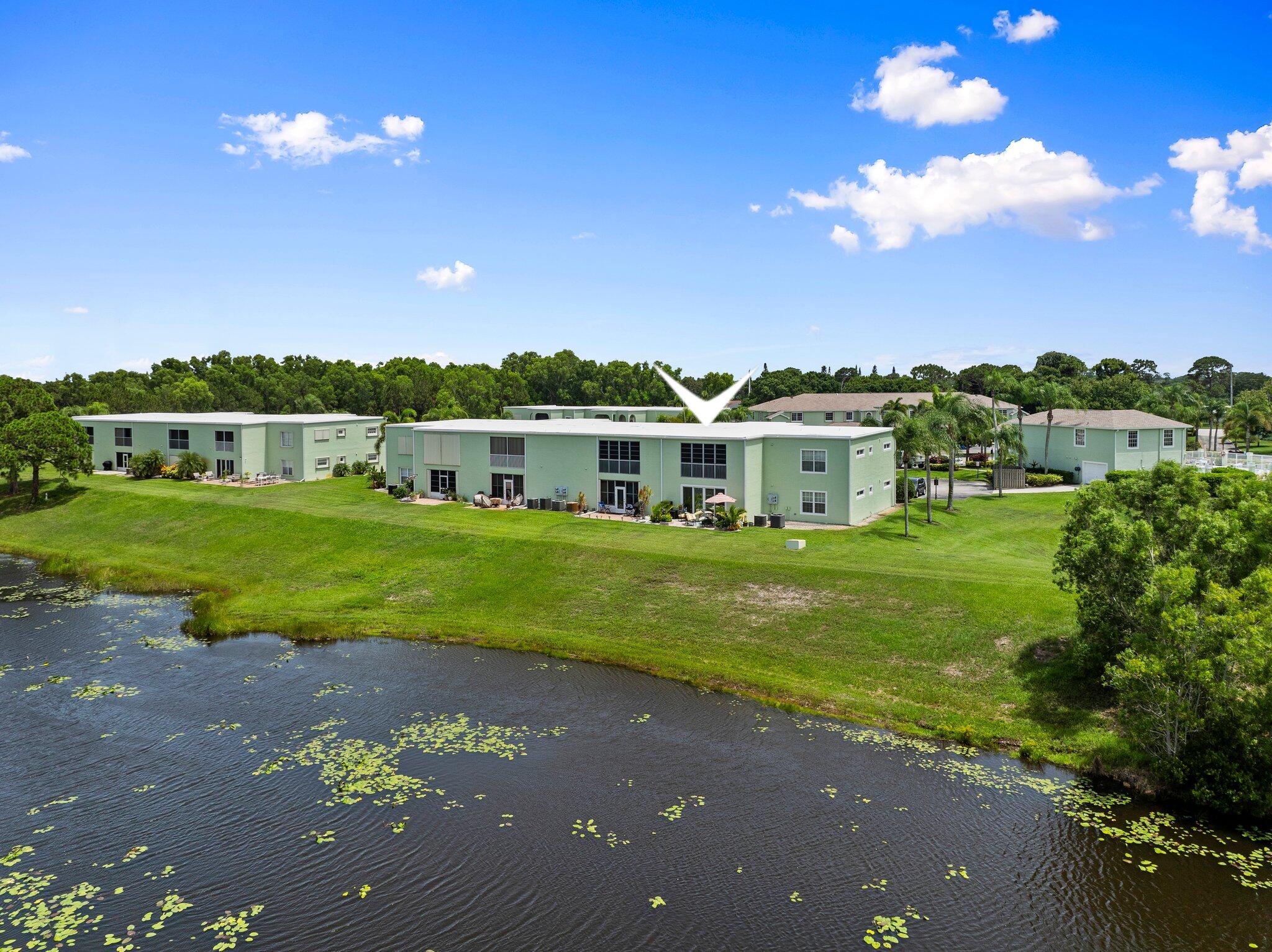 2186 Southeast Wild Meadow Circle Port St. Lucie, FL 34952 - Photo 48 of 57 a view of a house with a big yard