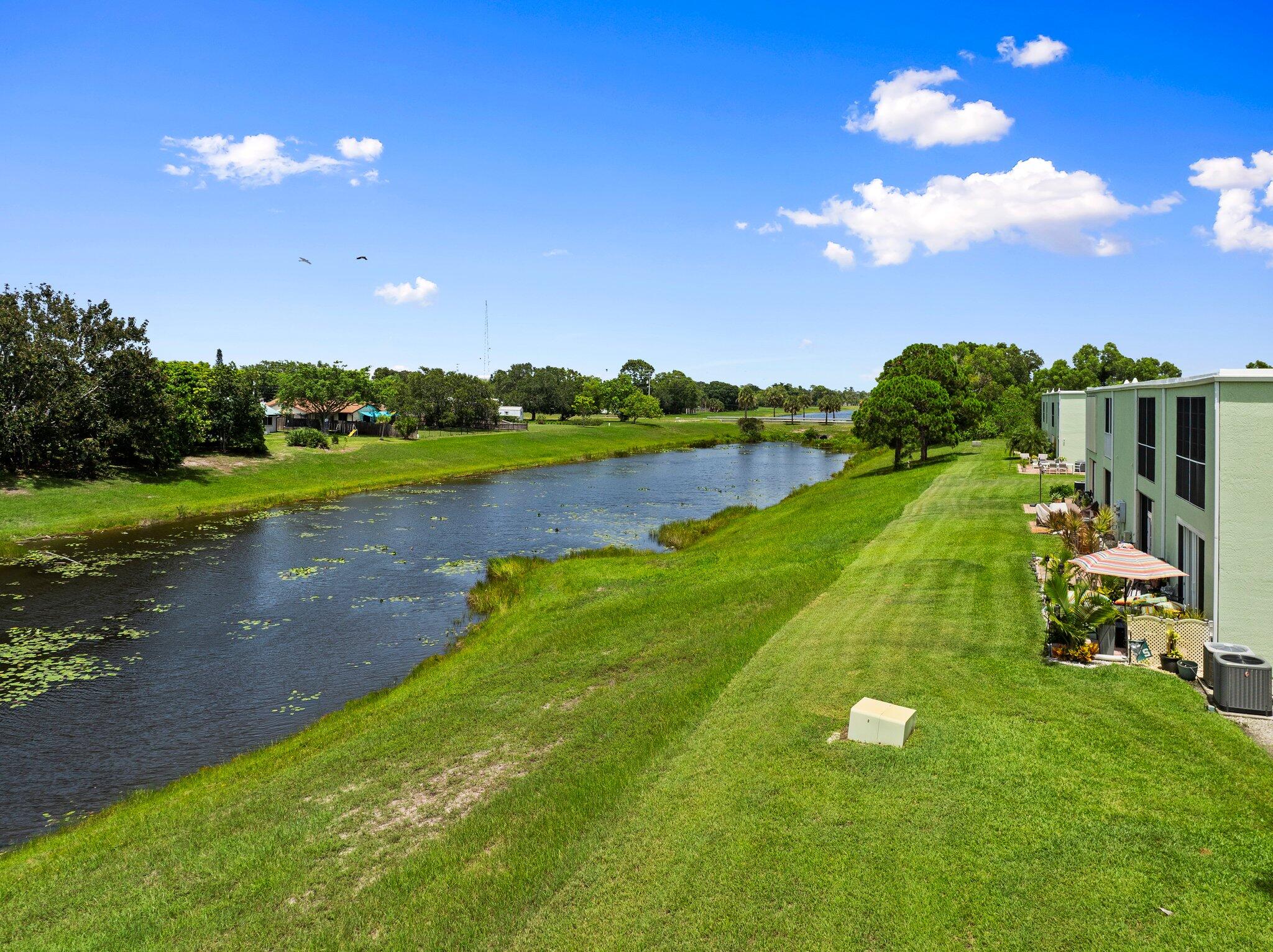 2186 Southeast Wild Meadow Circle Port St. Lucie, FL 34952 - Photo 52 of 57 a view of a golf course with a lake