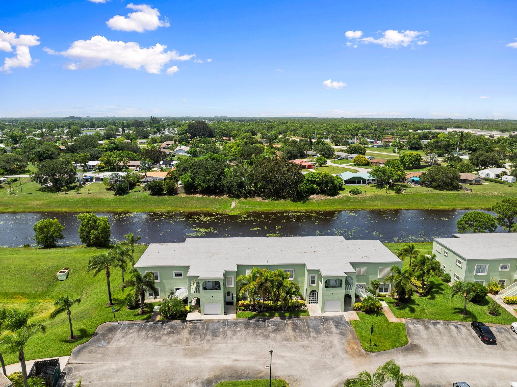 2186 Southeast Wild Meadow Circle Port St. Lucie, FL 34952 - Photo 55 of 57 an aerial view of a houses with outdoor space and lake view