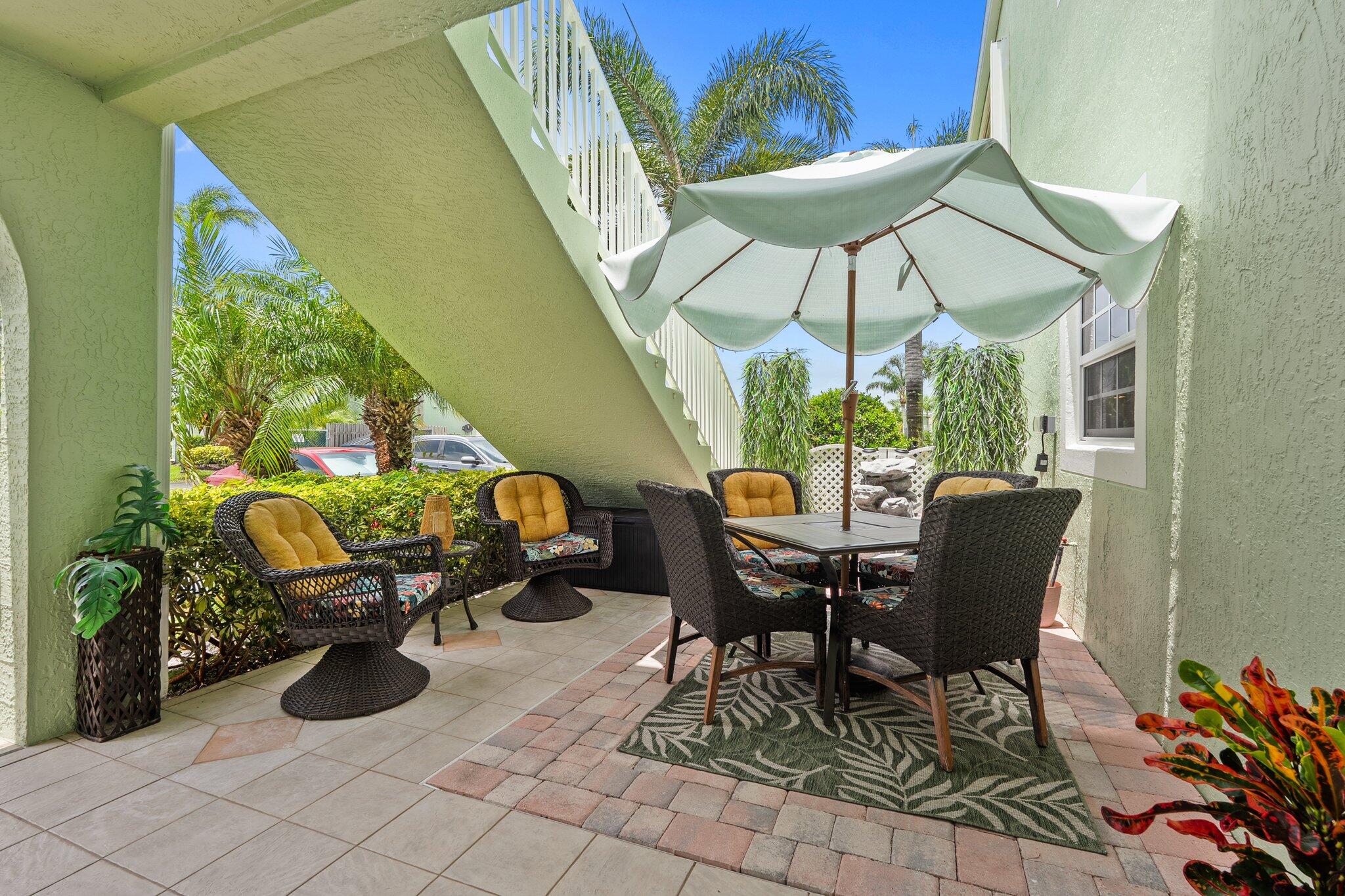 2186 Southeast Wild Meadow Circle Port St. Lucie, FL 34952 - Photo 8 of 57 a view of a dining table and chairs in patio