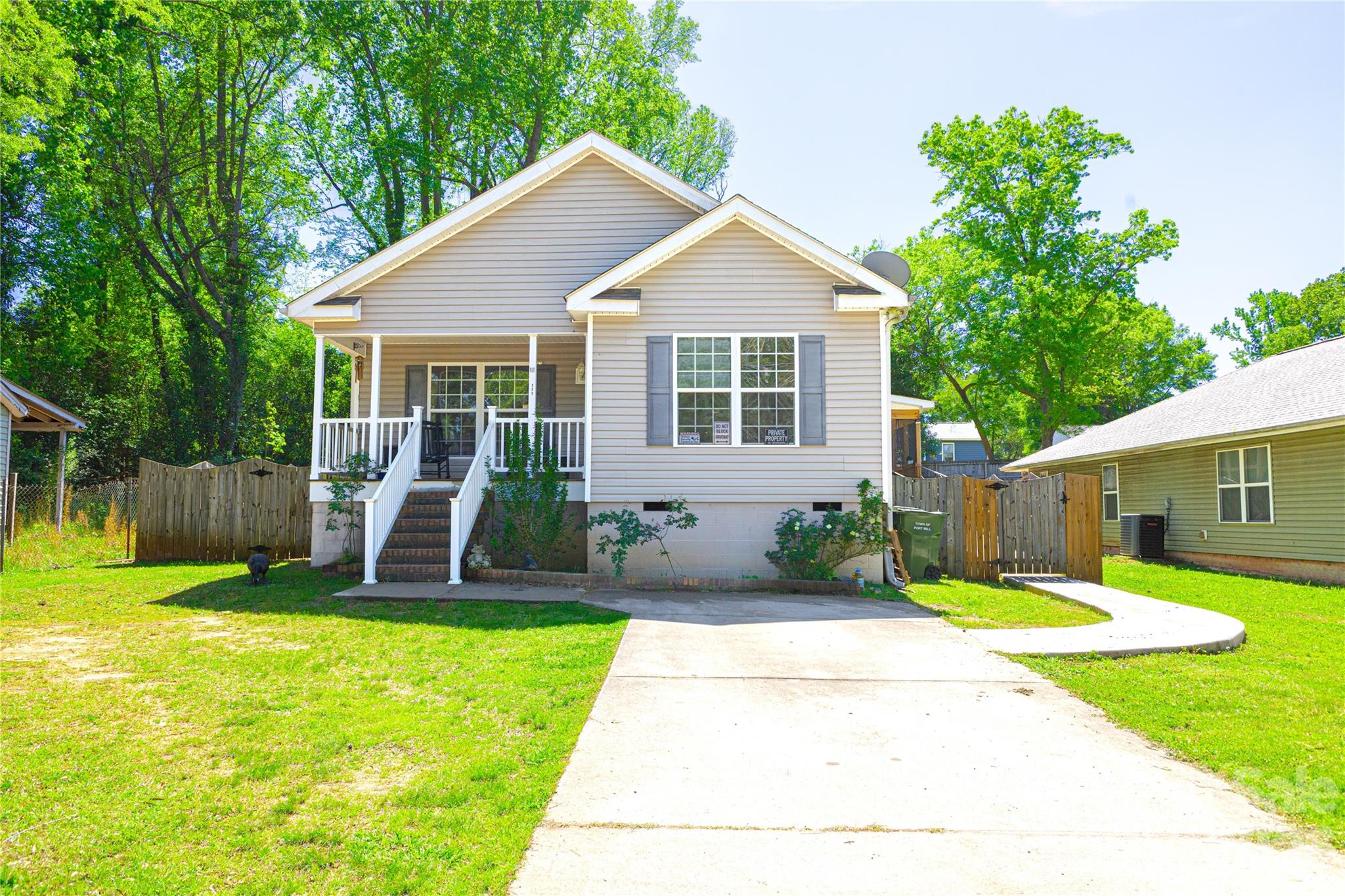 a view of a house with a yard patio and a small yard