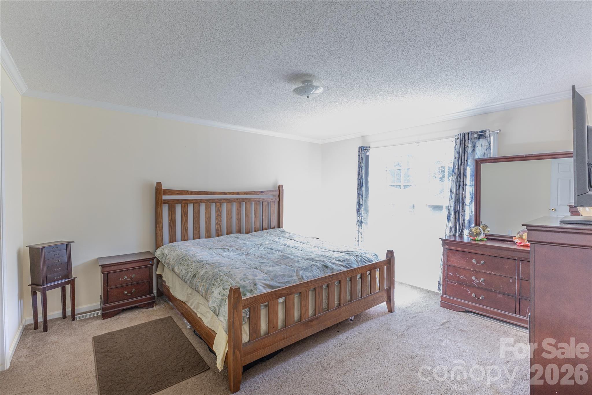 111 Berry Street Fort Mill, SC 29715 - Photo 7 of 19 a bedroom with a bed and a table in it