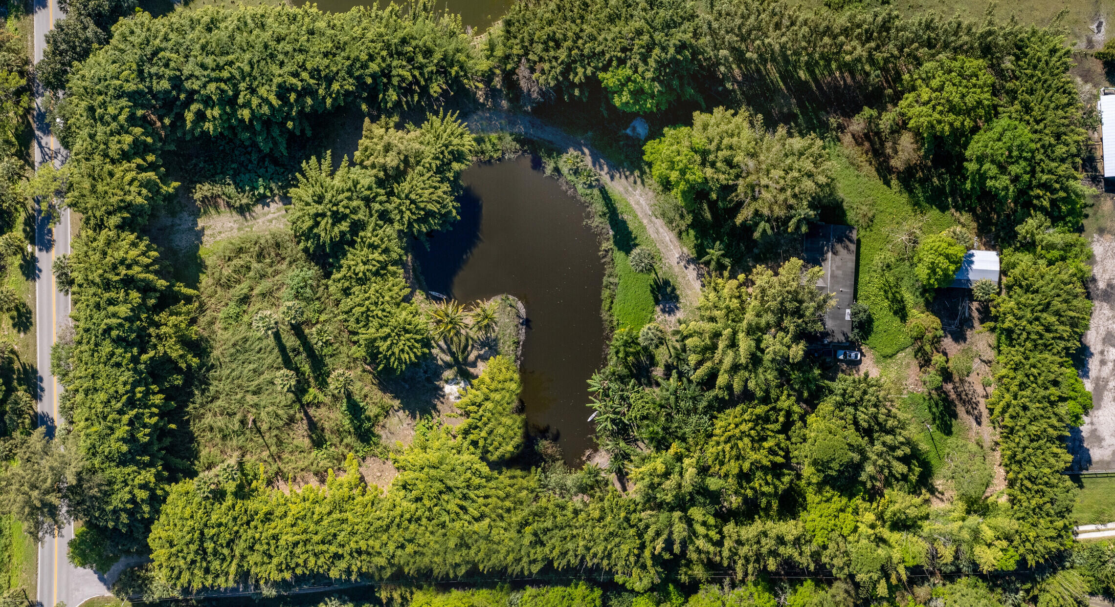 an aerial view of a house with a yard and lake view