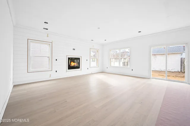 an empty space with window and hardwood floor