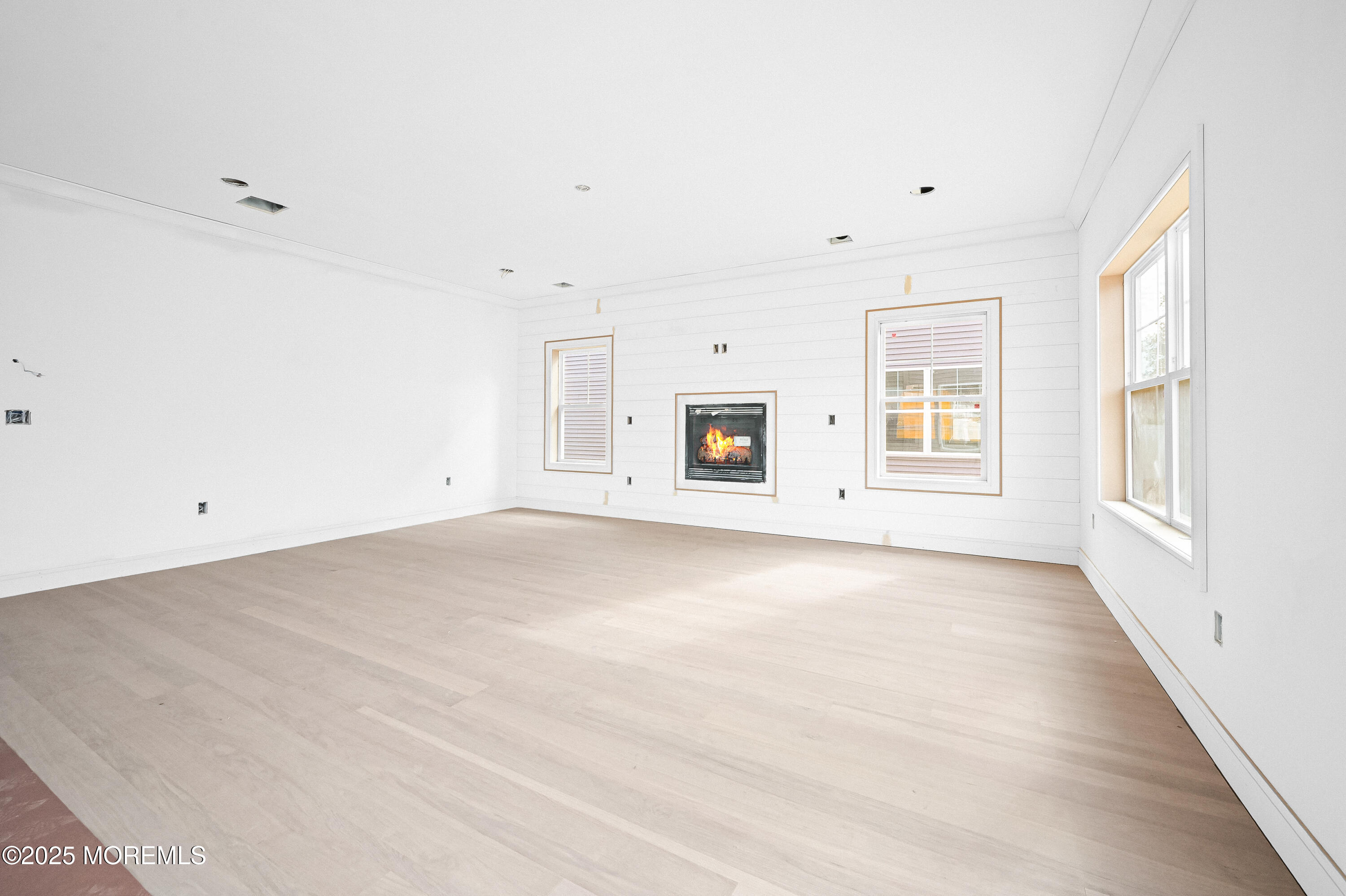 74 Manchester Avenue Keyport, NJ 07735 - Photo 5 of 14 an empty room with windows and fireplace