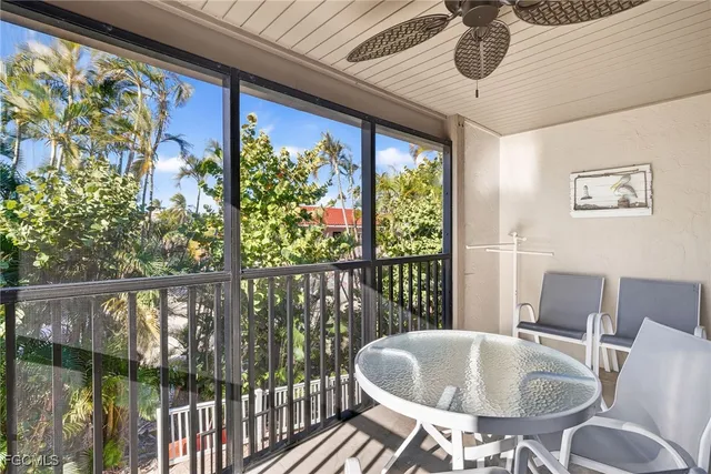 a dining room with furniture and a floor to ceiling window