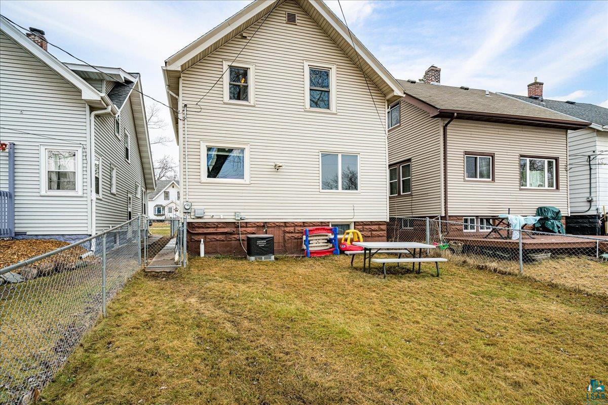 4316 West 6th Street Duluth, MN 55807 - Photo 11 of 39 Rear view of house featuring a fenced backyard and a gate