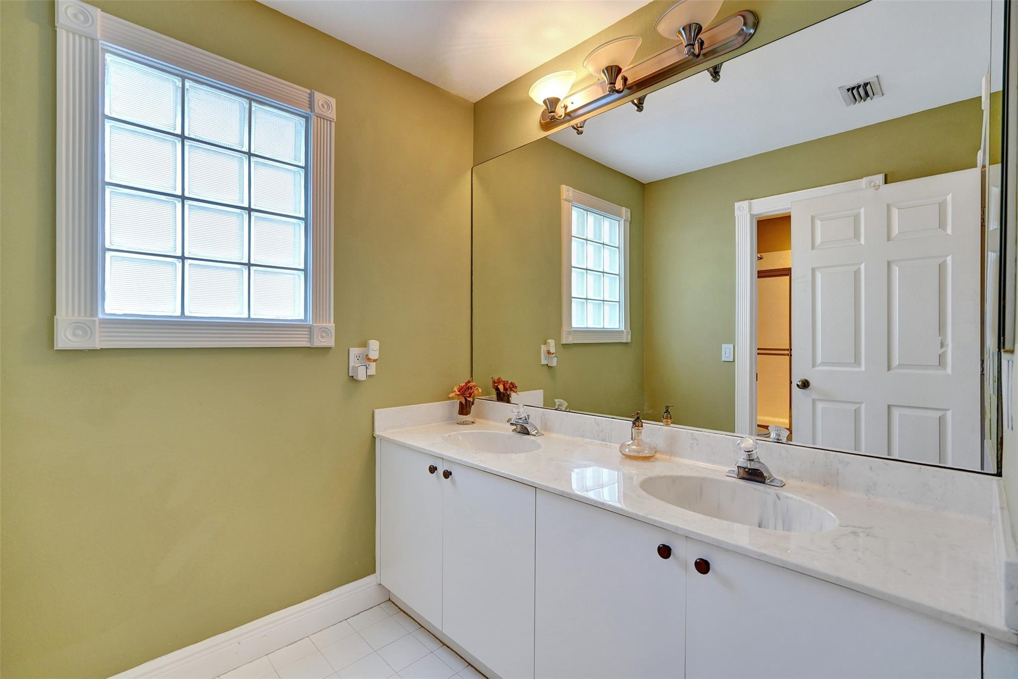 10902 Tamoron Lane Boca Raton, FL 33498 - Photo 43 of 66 a bathroom with a sink and a mirror