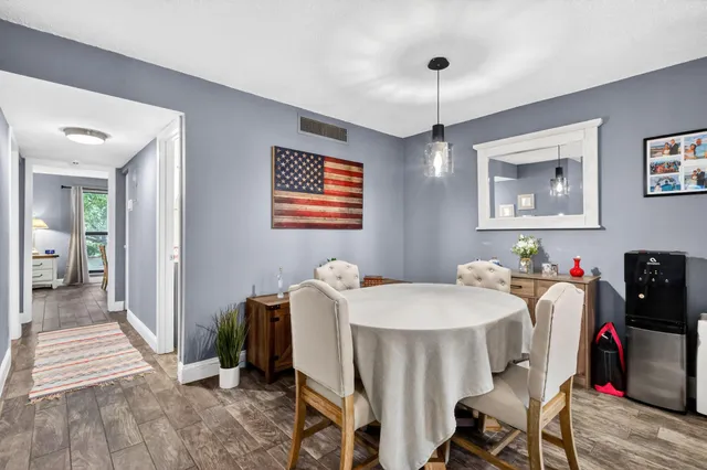 a dining room with furniture and window