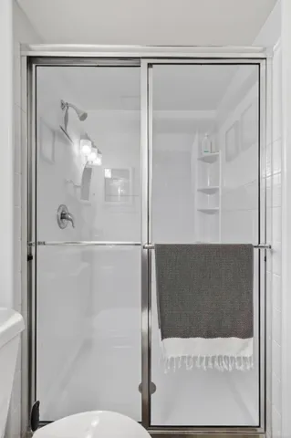 a bathroom with a glass shower door
