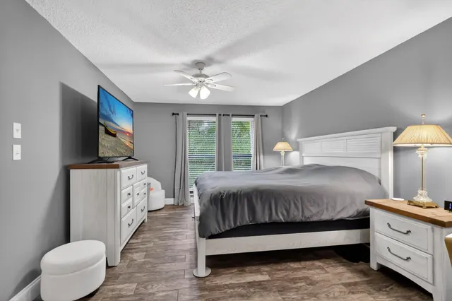 a bedroom with a large bed and a chandelier
