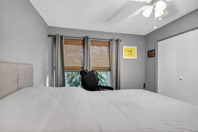 a bedroom with a large bed and a chandelier