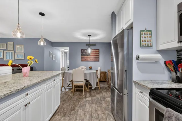 a kitchen that has a sink a counter space and stainless steel appliances