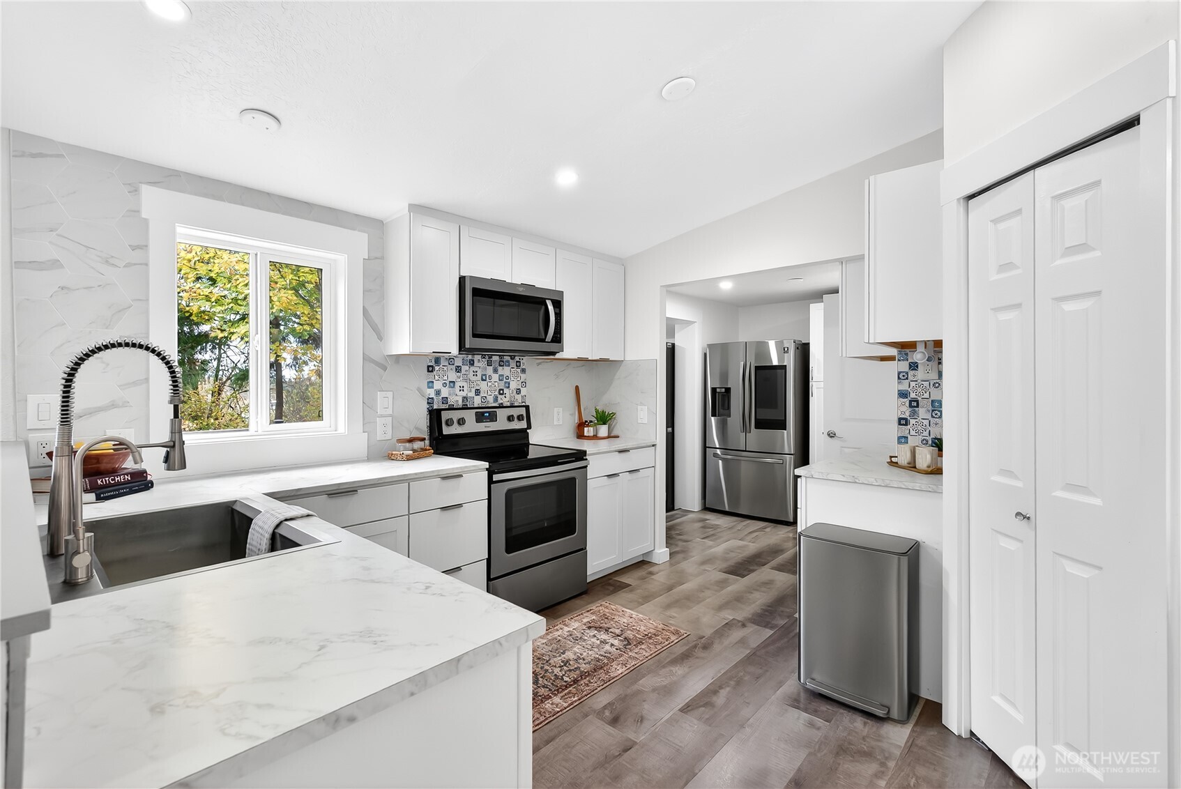 6583 Goodwin Road Everson, WA 98247 - Photo 12 of 40 a large kitchen with a refrigerator a sink a stove and cabinets