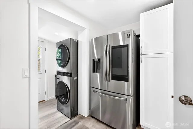 a view of kitchen with stainless steel appliances refrigerator and cabinets