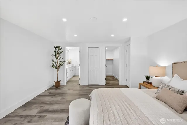 a spacious bedroom with a bed and a chandelier