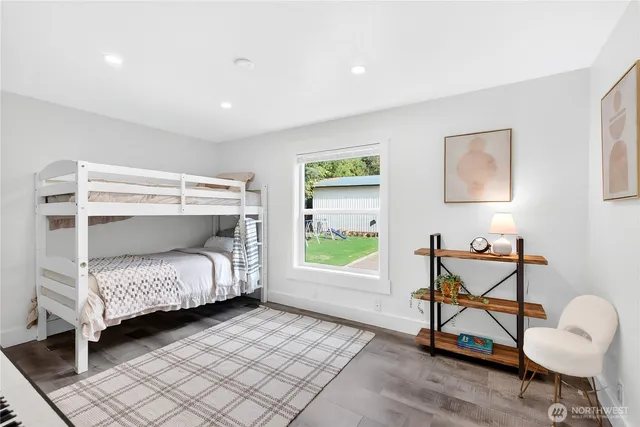 a bedroom with a bed a desk and chair