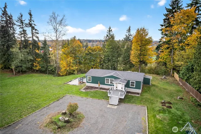an aerial view of a house with a big yard
