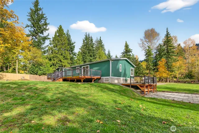 a view of a house with a yard and sitting area