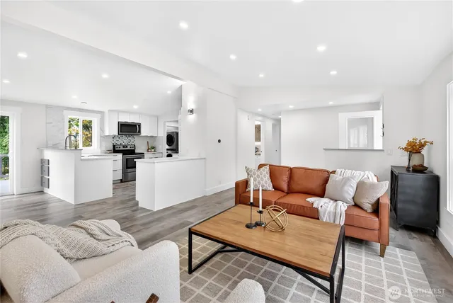 a living room with furniture and kitchen view