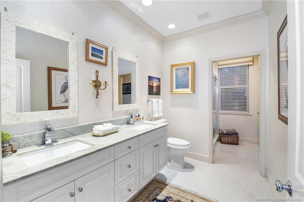 2109 Southeast Talbot Place Stuart, FL 34997 - Photo 15 of 59 Third bath just off the kitchen is updated with quartzite countertops and doubles as an ensuite bath for the 3rd bedroom