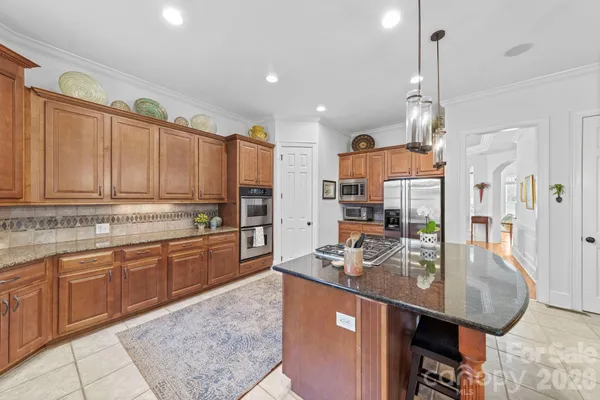 a spacious bathroom with a granite countertop sink a mirror and a shower