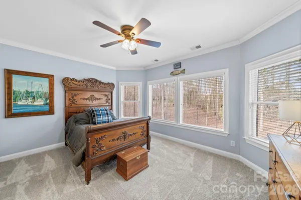 a bedroom with a large bed and a large window