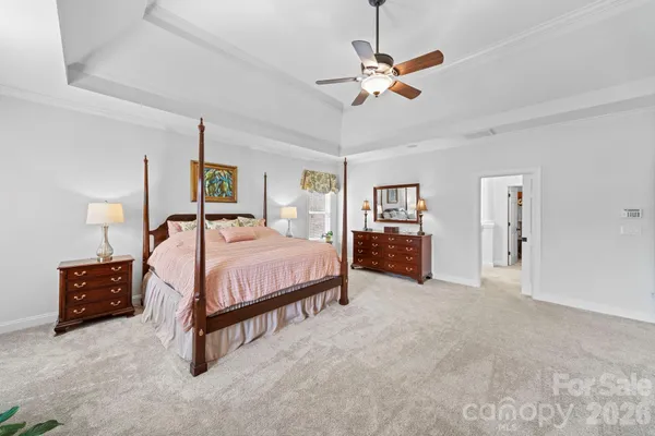a living room with furniture tv and a floor to ceiling window