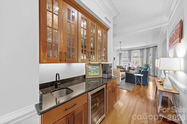a dining room with furniture a chandelier and wooden floor