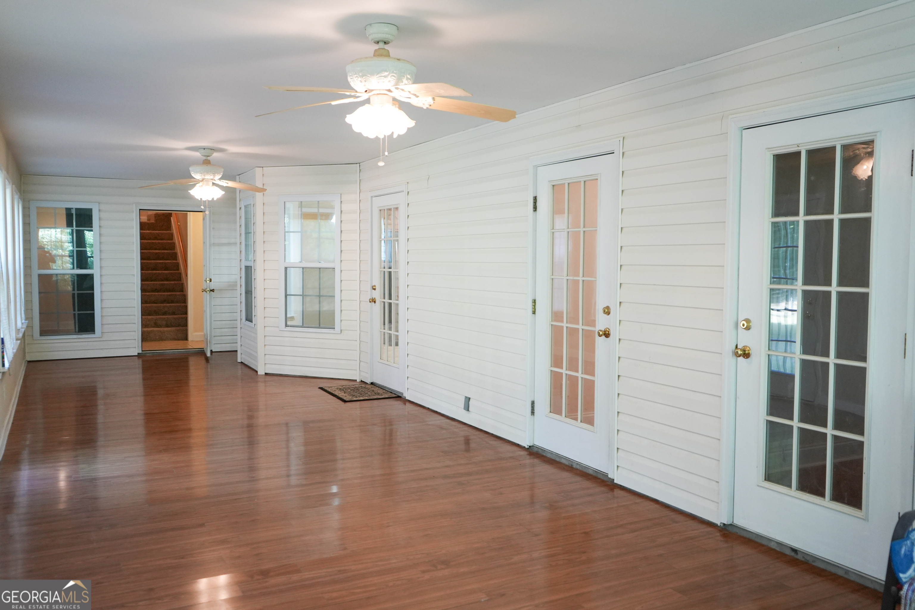 1293 Payne Road Rentz, GA 31075 - Photo 29 of 40 an empty room with wooden floor and windows