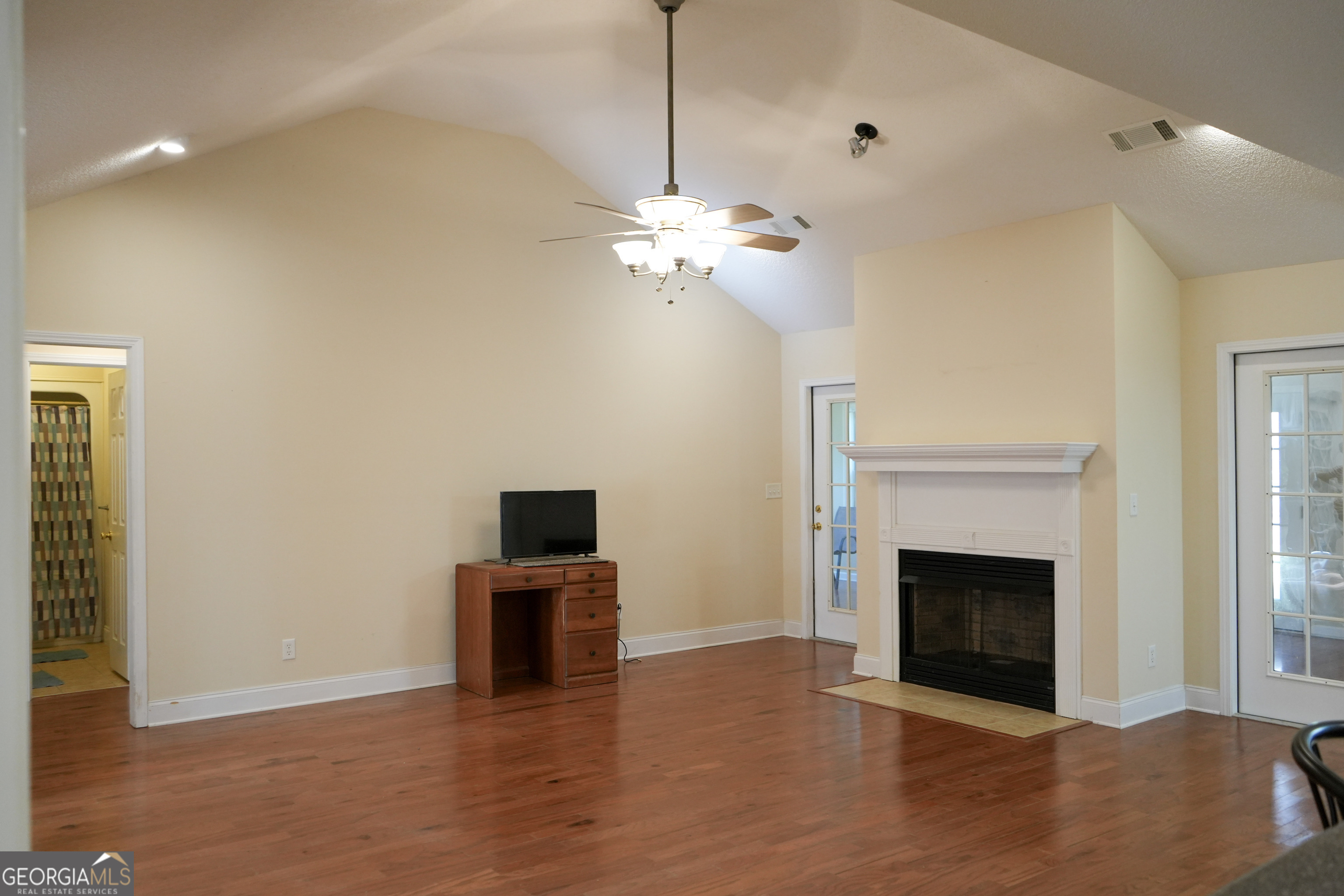1293 Payne Road Rentz, GA 31075 - Photo 6 of 40 a view of an empty room with a fireplace and a window