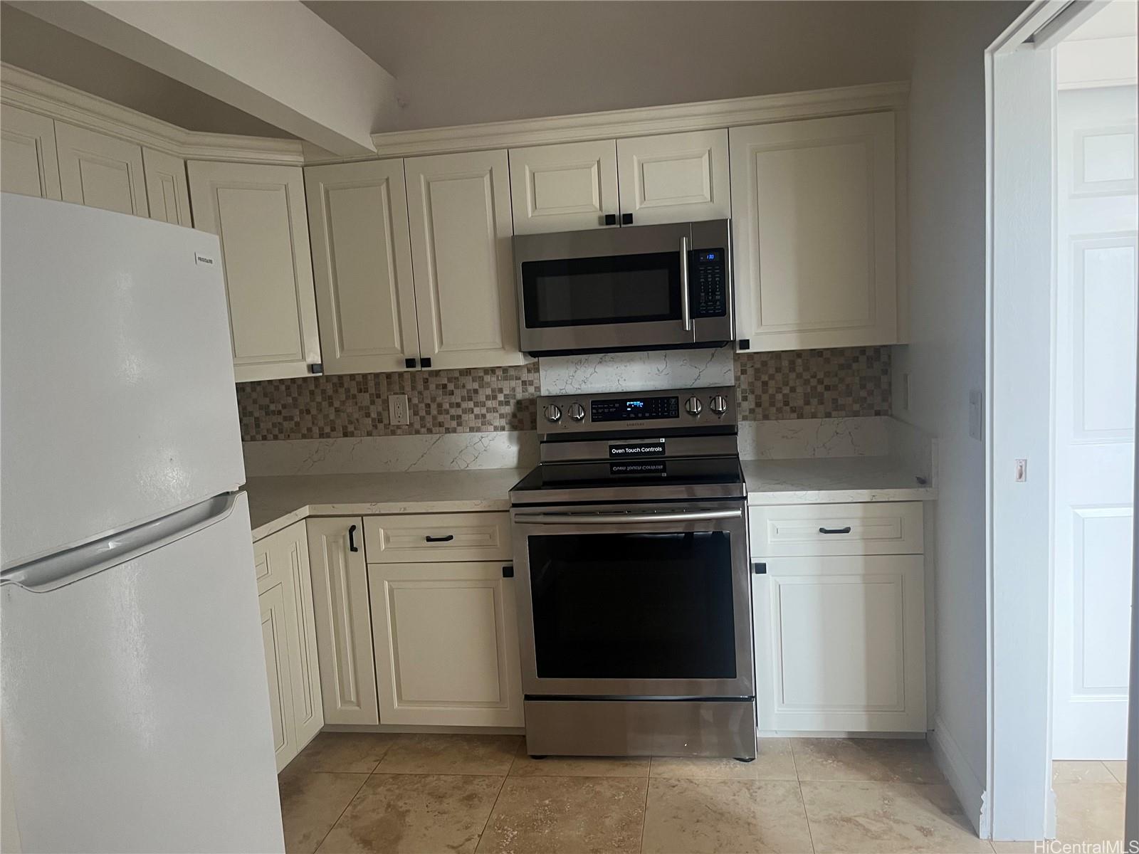 2067 Omea Place Honolulu, HI 96821 - Photo 6 of 9 a kitchen with stainless steel appliances white cabinets and a stove