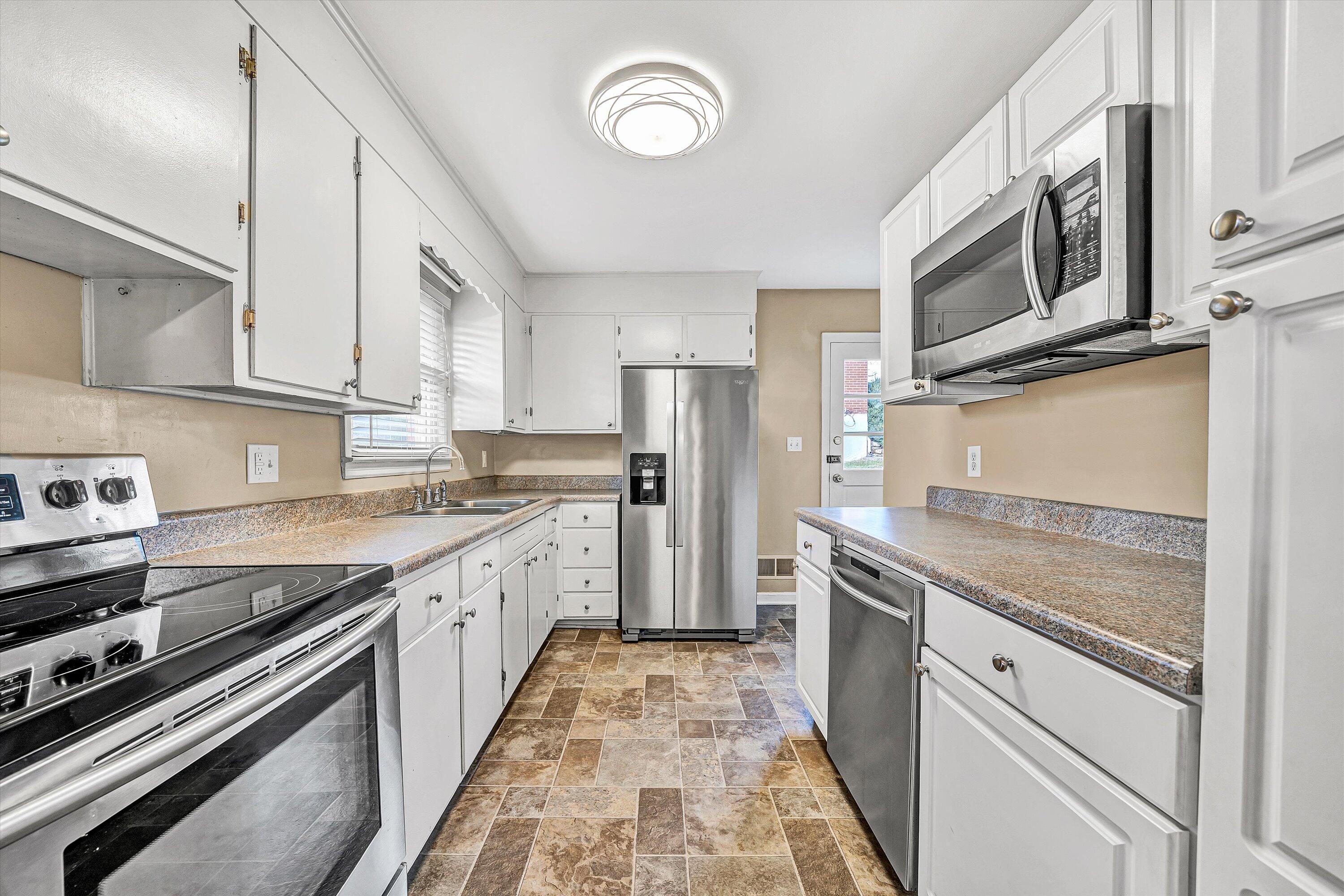 519 Doyle Street Salem, VA 24153 - Photo 14 of 40 a kitchen with stainless steel appliances granite countertop a stove and a sink