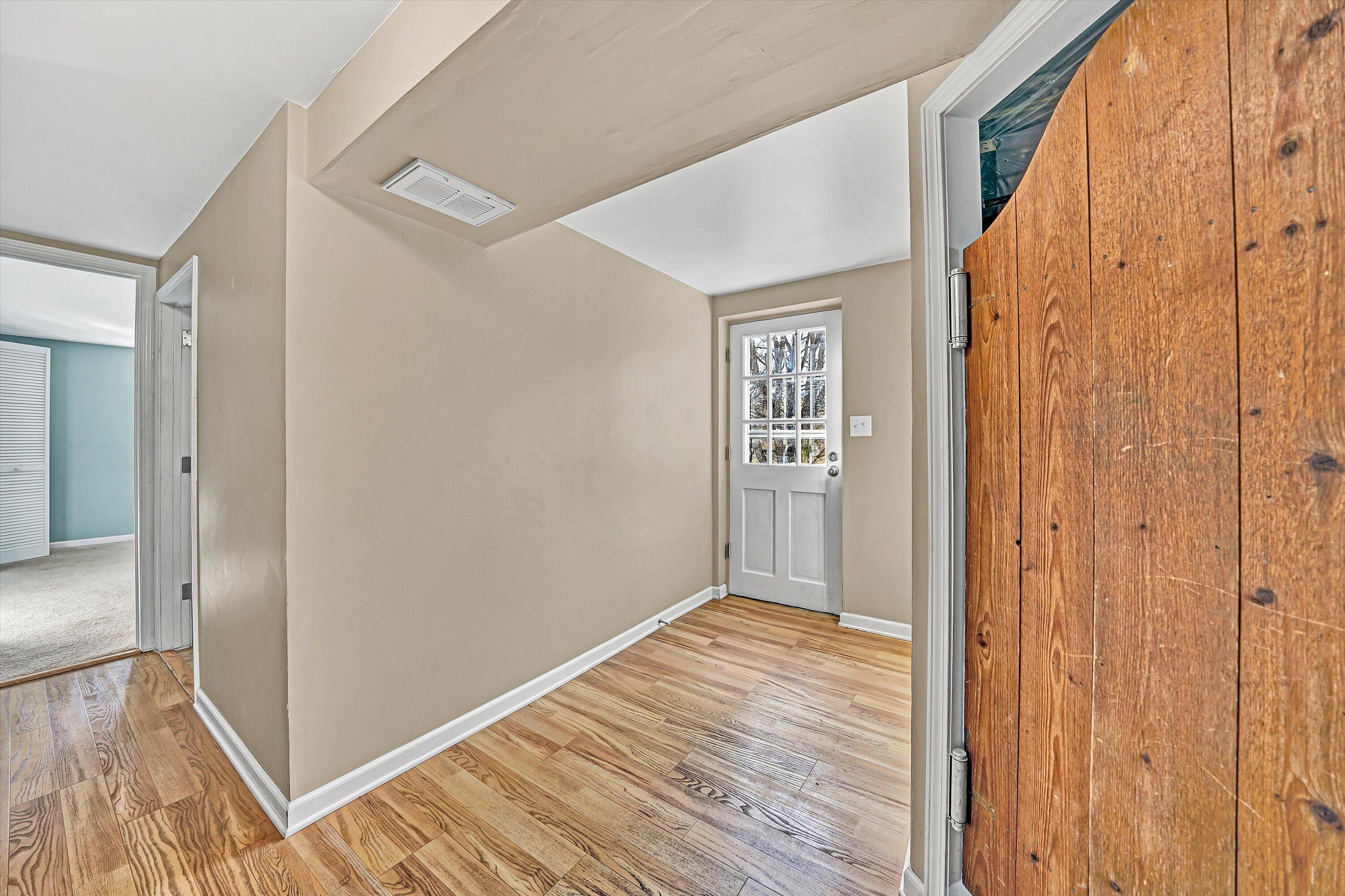 519 Doyle Street Salem, VA 24153 - Photo 22 of 40 a view of a hallway with wooden floor and a bathroom