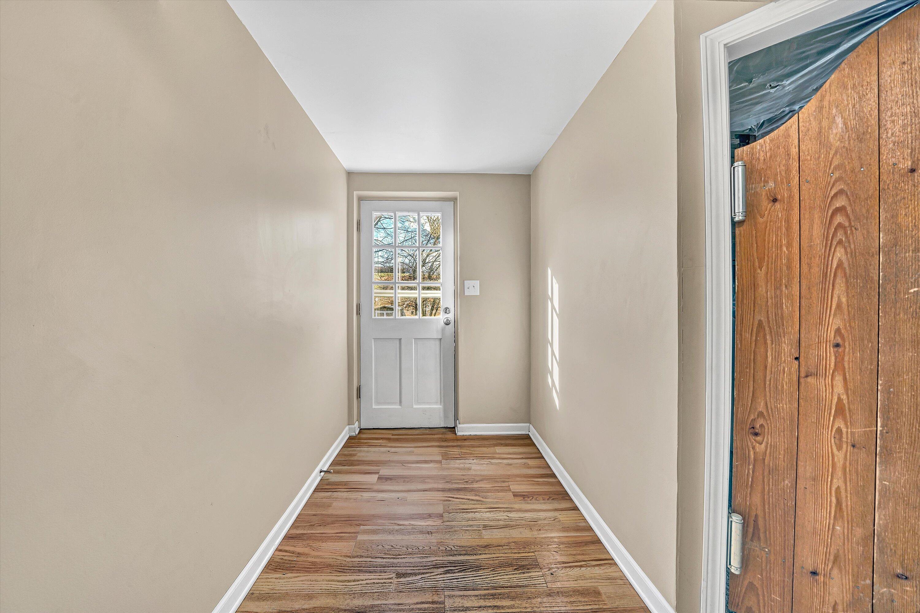 519 Doyle Street Salem, VA 24153 - Photo 23 of 40 a view of a hallway with wooden floor and a bathroom