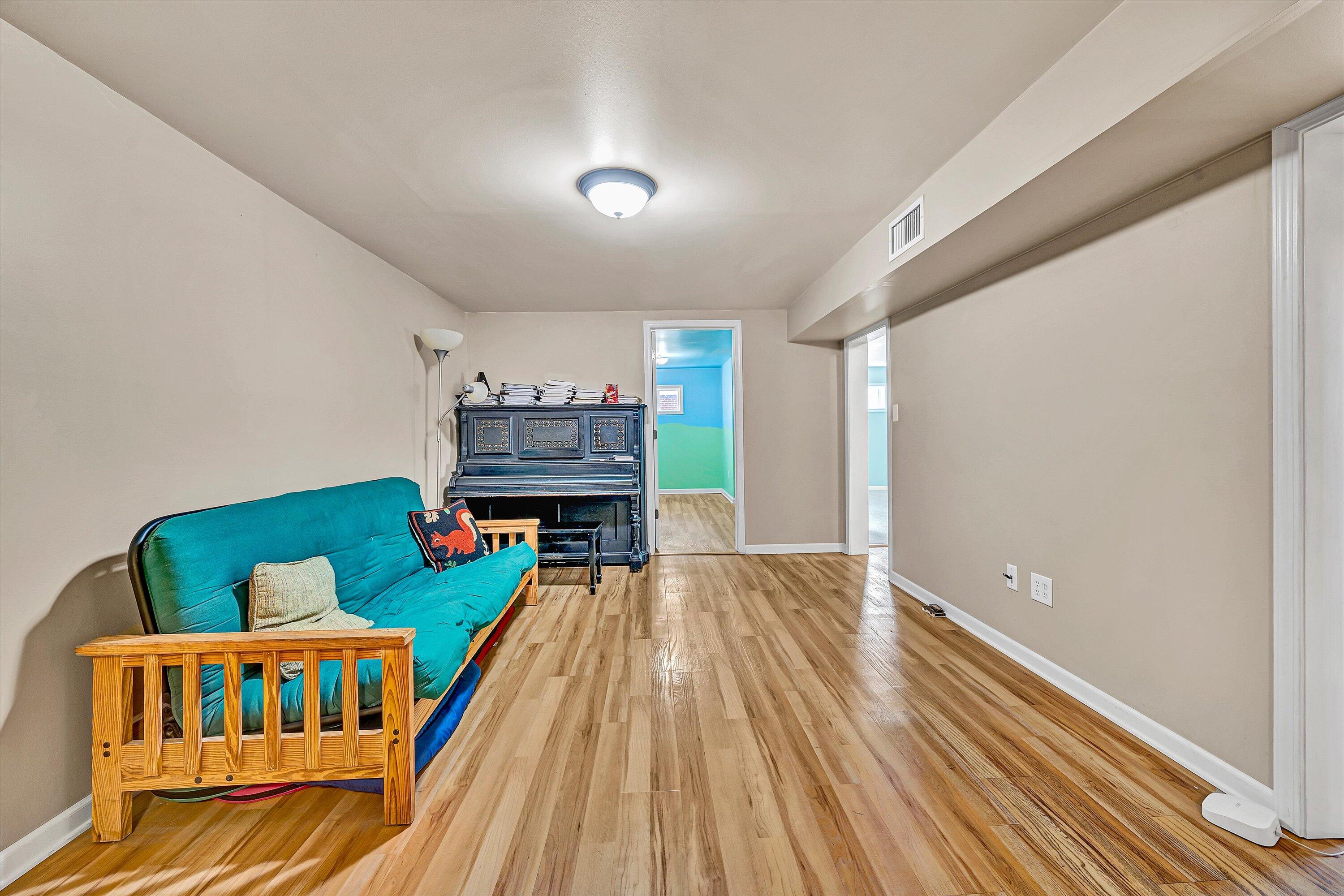 519 Doyle Street Salem, VA 24153 - Photo 25 of 40 a living room with baby crib furniture and a wooden floor