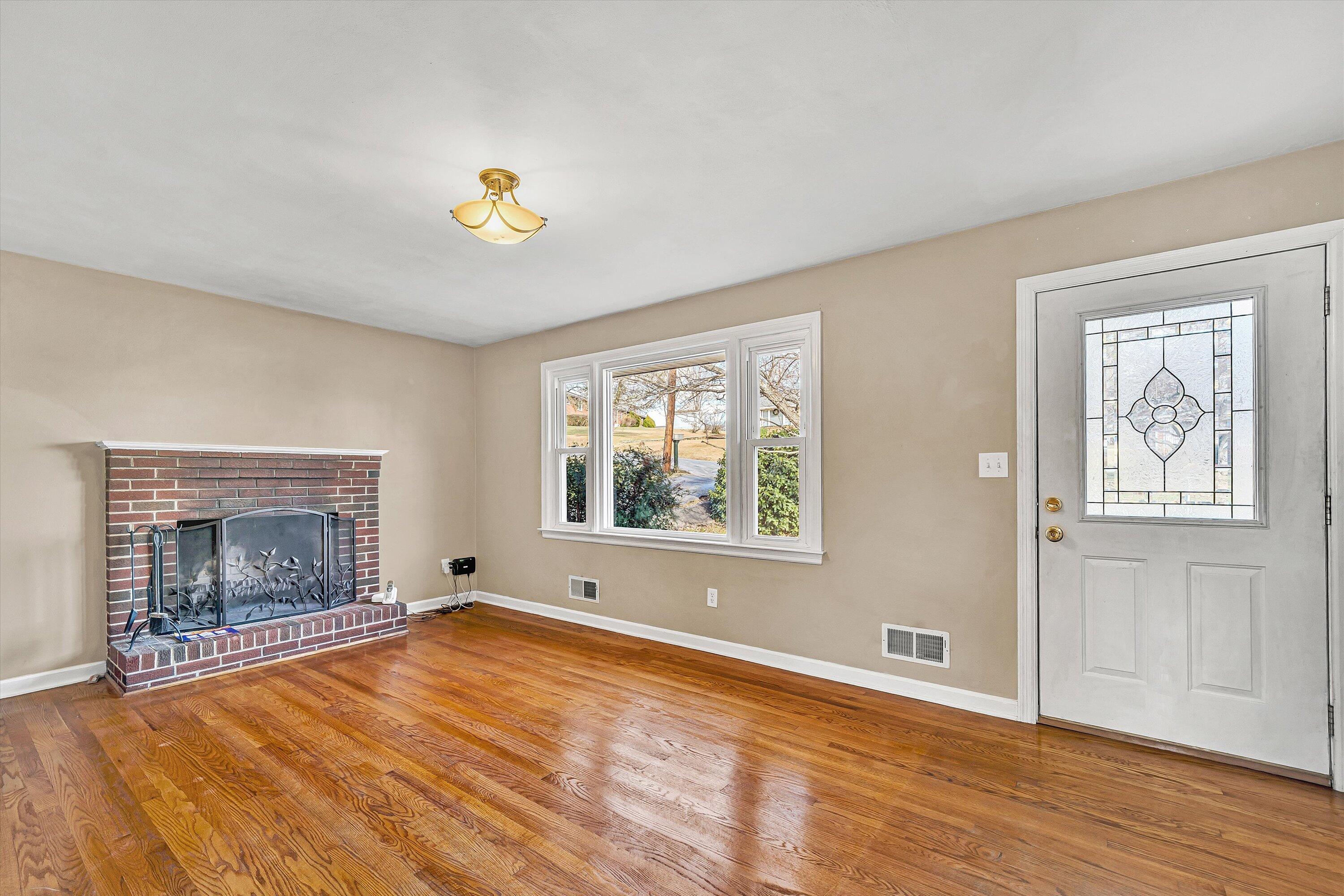 519 Doyle Street Salem, VA 24153 - Photo 5 of 40 an empty room with windows and fireplace