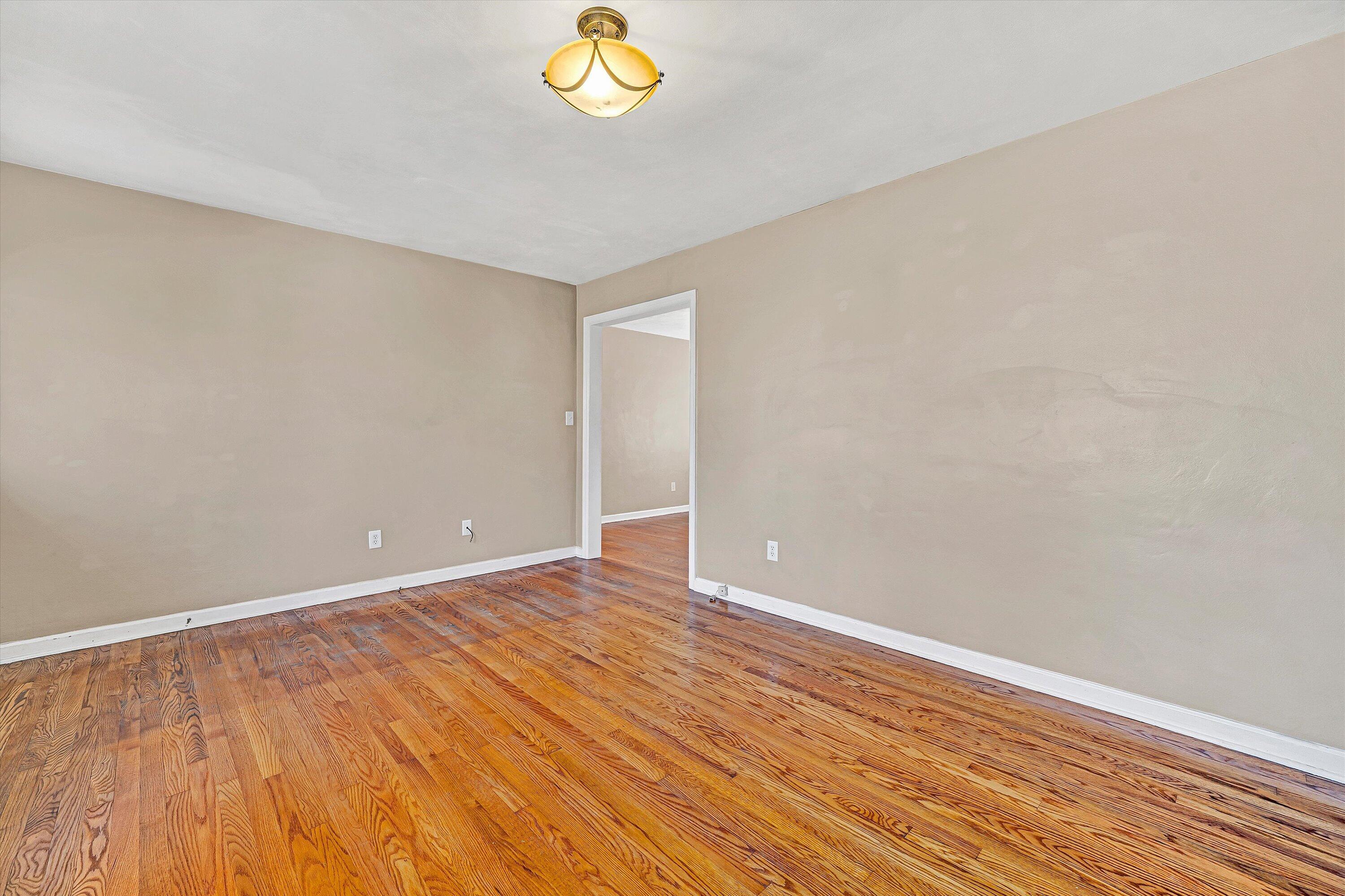 519 Doyle Street Salem, VA 24153 - Photo 7 of 40 a view of an empty room with wooden floor and a window