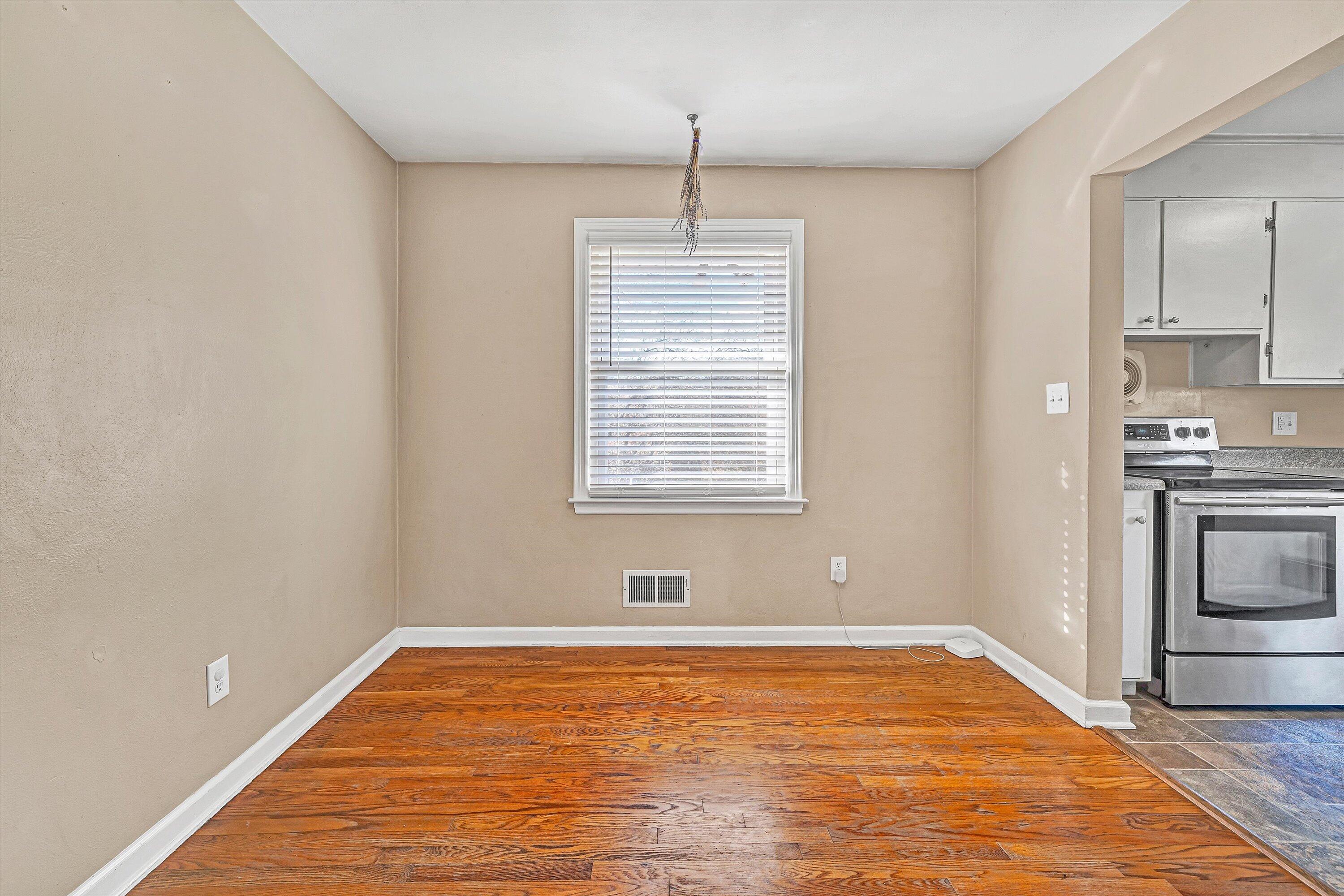 519 Doyle Street Salem, VA 24153 - Photo 10 of 40 a view of empty room with wooden floor and kitchen