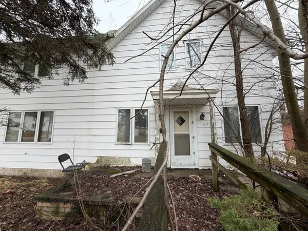 a front view of a house with chairs