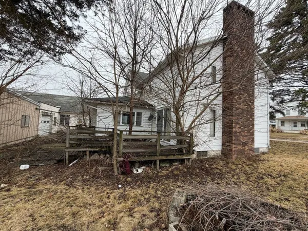 a view of a house with a yard and sitting area